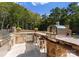 Outdoor kitchen featuring stone counters, stainless steel appliances, and a pizza oven perfect for entertaining at 2723 Providence Pine Ln, Charlotte, NC 28270