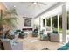 Bright sunroom with large windows, fireplace, neutral tones, and cozy seating arrangement at 2723 Providence Pine Ln, Charlotte, NC 28270