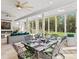 Well lit sunroom with dining table, fireplace, and cozy seating area at 2723 Providence Pine Ln, Charlotte, NC 28270