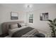 Virtually staged bedroom with window and neutral decor at 2807 Station Sw Ln, Concord, NC 28025