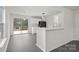 Kitchen with white cabinets, island, and sliding glass door to deck at 2807 Station Sw Ln, Concord, NC 28025