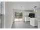 Kitchen with white cabinets, a sliding glass door to a deck, and gray flooring at 2807 Station Sw Ln, Concord, NC 28025