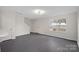 Bright living room with gray flooring and a view of a front yard at 2807 Station Sw Ln, Concord, NC 28025