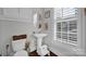 Clean bathroom with pedestal sink and window with shutters at 376 Delburg St, Davidson, NC 28036