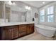 Bathroom boasts a soaking tub and double vanity at 376 Delburg St, Davidson, NC 28036