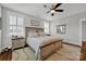 Bright bedroom featuring a king-size bed and wood floors at 376 Delburg St, Davidson, NC 28036