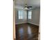 Bright bedroom featuring hardwood floors and a ceiling fan at 376 Delburg St, Davidson, NC 28036