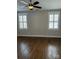 Spacious bedroom with hardwood floors, ceiling fan, and window shutters at 376 Delburg St, Davidson, NC 28036