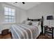 Cozy bedroom with a queen-size bed and wood floors at 376 Delburg St, Davidson, NC 28036