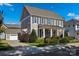 Two-story house with gray siding, shutters, and a front porch at 376 Delburg St, Davidson, NC 28036