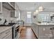 Modern kitchen with gray cabinets, granite countertops, and stainless steel appliances at 376 Delburg St, Davidson, NC 28036