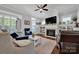 Living room with fireplace, built-ins, and hardwood floors at 376 Delburg St, Davidson, NC 28036