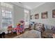 Well-lit playroom with hardwood floors and toy storage at 376 Delburg St, Davidson, NC 28036