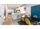 Open concept dining area with a black table and four mustard yellow chairs at 412 Tristram Ln, Charlotte, NC 28205