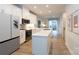 Modern white kitchen with stainless steel appliances and large island at 412 Tristram Ln, Charlotte, NC 28205