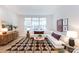 Spacious living room with L-shaped sofa, large windows, and patterned rug at 412 Tristram Ln, Charlotte, NC 28205