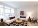 Living room with an L-shaped sofa, coffee table, and green accent chair at 412 Tristram Ln, Charlotte, NC 28205