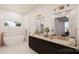 Elegant bathroom with double vanity, soaking tub, and gold fixtures at 1935 Weddington Rd # A, Matthews, NC 28105