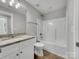 Bathroom with granite countertop, white cabinets, and a tub at 305 Gooch St, Lancaster, SC 29720