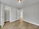 Bedroom with wood-look floors, closet, and access to another room at 305 Gooch St, Lancaster, SC 29720