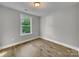 Simple bedroom with wood flooring and a window at 305 Gooch St, Lancaster, SC 29720