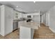 Modern kitchen featuring white cabinets, granite countertops, and stainless steel appliances at 305 Gooch St, Lancaster, SC 29720