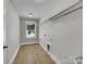 Laundry room with window, shelving, and wood-look flooring at 305 Gooch St, Lancaster, SC 29720