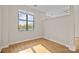 Bright bedroom with hardwood floors and large window at 708 N Davidson St, Charlotte, NC 28202