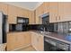 Modern kitchen with wood cabinets and black tile backsplash at 708 N Davidson St, Charlotte, NC 28202