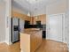 Kitchen island with granite countertop and stainless steel appliances at 708 N Davidson St, Charlotte, NC 28202