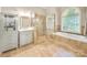 Spa-like bathroom with soaking tub, walk-in shower, and updated vanity at 128 Archbell Point Ln, Mooresville, NC 28117