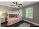 Cozy bedroom with bunk beds, ample natural light, and hardwood floors at 128 Archbell Point Ln, Mooresville, NC 28117