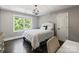 Spacious bedroom with queen bed, large window, and hardwood floors at 128 Archbell Point Ln, Mooresville, NC 28117