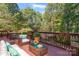 Deck with seating and dining area, offering a view of the backyard trees at 128 Archbell Point Ln, Mooresville, NC 28117