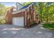 Brick home featuring an attached two car garage and mature landscaping at 128 Archbell Point Ln, Mooresville, NC 28117