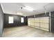 Spacious garage with light wood flooring and overhead door at 128 Archbell Point Ln, Mooresville, NC 28117
