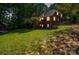 Brick house exterior with a deck and well-manicured lawn at 128 Archbell Point Ln, Mooresville, NC 28117