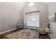 Bright home office features hardwood floors, large window, and comfortable seating at 128 Archbell Point Ln, Mooresville, NC 28117