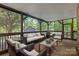 Relaxing screened porch with wicker furniture, perfect for enjoying the outdoors at 128 Archbell Point Ln, Mooresville, NC 28117