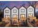 Rear view of townhomes showcasing private decks and fenced yards at 156 Mattoon St, Charlotte, NC 28216