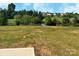 Expansive backyard featuring a scenic pond, lush greenery, and a serene view of the neighborhood at 209 Lake George Dr, Shelby, NC 28152