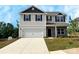 Charming two-story home with a two-car garage, stone accents, and a well-maintained lawn at 209 Lake George Dr, Shelby, NC 28152
