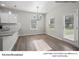 Bright kitchen and breakfast area with modern lighting, granite counters and wood look floors at 209 Lake George Dr, Shelby, NC 28152