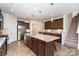 Open kitchen with large island, stainless steel appliances, and dark wood cabinetry at 255 Olive St, Fort Mill, SC 29715