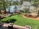 Picture-perfect backyard showcasing a lake view, lush lawn, and a covered dock at 377 Riverwood Rd, Mooresville, NC 28117