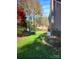 Lush backyard with manicured lawn, lake view, and mature trees at 377 Riverwood Rd, Mooresville, NC 28117