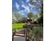 Multi-level backyard with lake view, featuring lush landscaping and mature trees at 377 Riverwood Rd, Mooresville, NC 28117