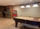 Basement includes a pool table, kitchenette, and unique lighting at 377 Riverwood Rd, Mooresville, NC 28117