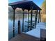 Dock with boat lift on a calm lake, surrounded by lush trees, ideal for waterfront living at 377 Riverwood Rd, Mooresville, NC 28117