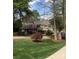 Traditional home featuring mature landscaping, a two car garage, and an American flag at 377 Riverwood Rd, Mooresville, NC 28117